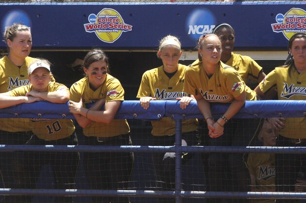 Missouri players watch from the dugout in the seventh inning of their elimination game in the NCAA championship softball tournament, in Oklahoma City, Saturday, June 5, 2010. Florida won 5-0. (AP Photo/Sue Ogrocki)