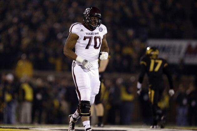 Texas A&M offensive linesman Cedric Ogbuehi jogs off the field during the first half of an NCAA college football game against Missouri on Saturday, Nov. 30, 2013, in Columbia, Mo. (AP Photo/Jeff Roberson)