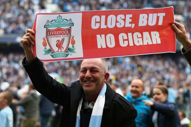 MANCHESTER, ENGLAND - MAY 11:  A Manchester City fan shows off a banner mocking Liverpool at the end of the Barclays Premier League match between Manchester City and West Ham United at the Etihad Stadium on May 11, 2014 in Manchester, England.  (Photo by Alex Livesey/Getty Images)