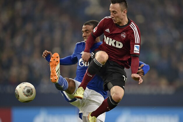 Nuremberg's Josip Drmic of Switzerland , right, and Schalke's Joel Matip of Cameroon challenge for the ball during the German Bundesliga soccer match between FC Schalke 04 and 1. FC Nuremberg in Gelsenkirchen,  Germany, Saturday, May 10, 2014. (AP Photo/Martin Meissner)