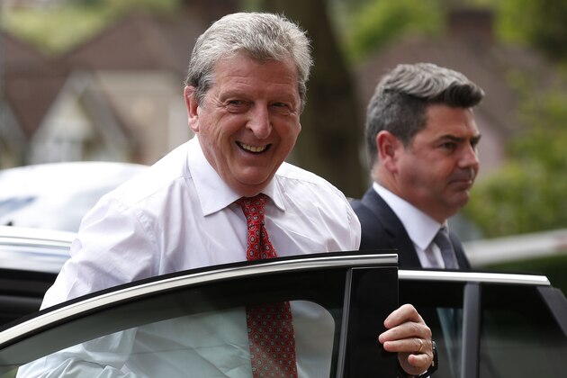 England's soccer manager Roy Hodgson, left, arrives to announce the national squad for the upcoming World Cup in Brazil, in Luton, England, Monday, May 12, 2014.(AP Photo/Sang Tan)