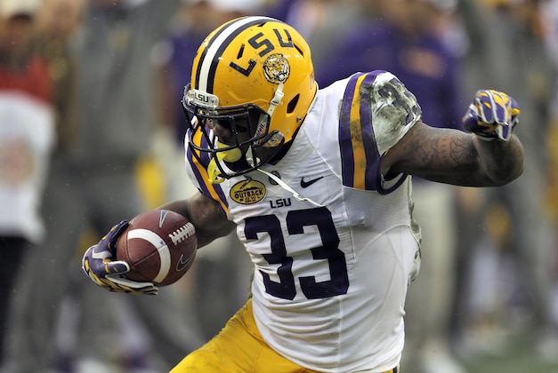 LSU running back Jeremy Hill (33) carries the ball during the second quarter of the NCAA college football game against Iowa Wednesday, Jan. 1, 2014, in Tampa, Fla. Hill, the game's most valuable player, scored two touchdowns in LSU's 21-14 win. (AP Photo/Chris O'Meara)