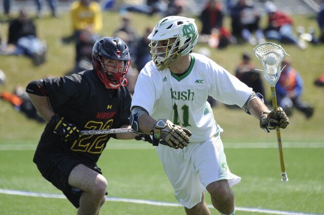 Notre Dame midfielder Pat Cotter heads up field as Maryland midfielder Nick Manis defends  in an college lacrosse game between Maryland and Notre Dame Saturday April 19, 2014 in South Bend, Ind. (AP Photo/Joe Raymond)