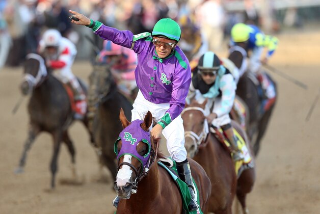 LOUISVILLE, KY - MAY 03:  Jockey Victor Espinoza celebrates atop of California Chrome #5 after crossing the finish line to win the 140th running of the Kentucky Derby at Churchill Downs on May 3, 2014 in Louisville, Kentucky.  (Photo by Matthew Stockman/Getty Images)