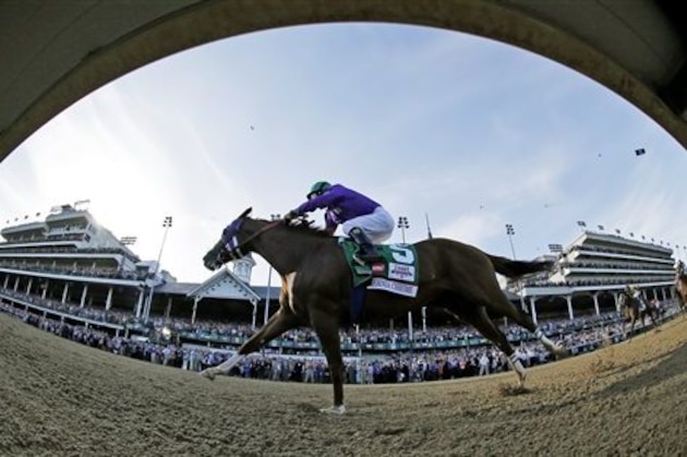 In this image taken with a fisheye lens, jockey Victor Espinoza rides California Chrome to win the 140th running of the Kentucky Derby horse race at Churchill Downs Saturday, May 3, 2014, in Louisville, Ky. (AP Photo/Matt Slocum)