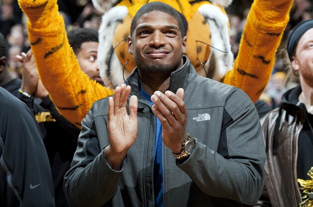 FILE - In this Feb. 15, 2014, file photo, Missouri's All-American defensive end Michael Sam claps during the Cotton Bowl trophy presentation at halftime of an NCAA college basketball game between Missouri and Tennessee in Columbia, Mo. Sam was selected in the seventh round, 249th overall, by the St. Louis Rams in the NFL draft Saturday, May 10, 2014. The Southeastern Conference defensive player of the year last season for Missouri came out as gay in media interviews this year.   (AP Photo/L.G. Patterson, File)
