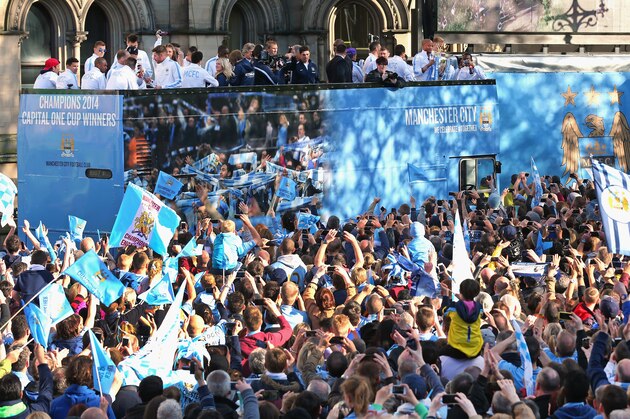 MANCHESTER, ENGLAND - MAY 12:  Vincent Kompany of Manchester City lifts the Barclays Premier League trophy aloft outside Manchester Town Hall at the start of the Manchester City victory parade around the streets of Manchester on May 12, 2014 in Manchester, England.  (Photo by Alex Livesey/Getty Images)