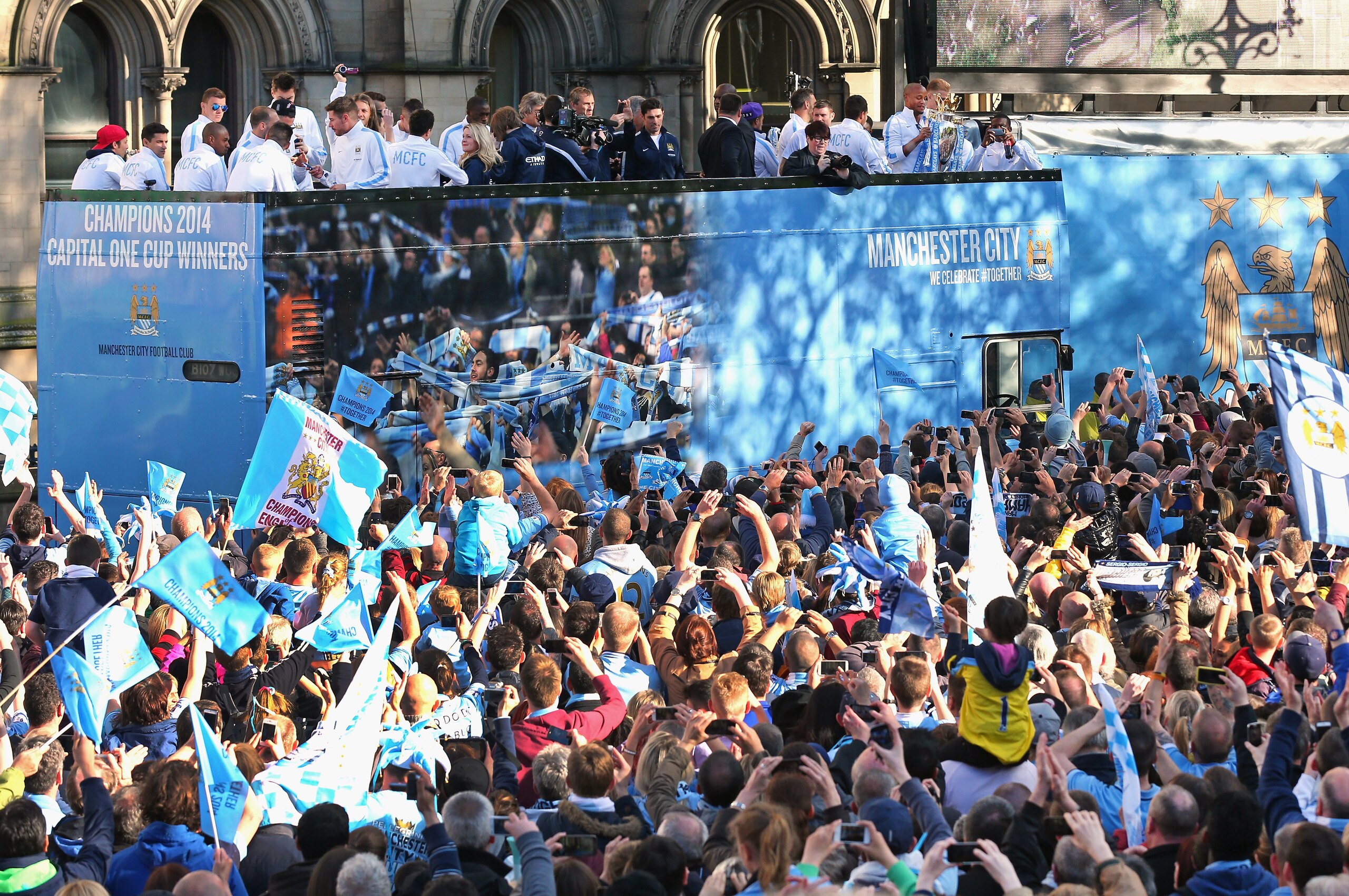 MANCHESTER, ENGLAND - MAY 12:  Vincent Kompany of Manchester City lifts the Barclays Premier League trophy aloft outside Manchester Town Hall at the start of the Manchester City victory parade around the streets of Manchester on May 12, 2014 in Manchester, England.  (Photo by Alex Livesey/Getty Images)