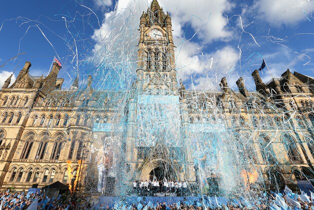 MANCHESTER, ENGLAND - MAY 12:  Vincent Kompany of Manchester City lifts the Barclays Premier League trophy aloft outside Manchester Town Hall at the start of the Manchester City victory parade around the streets of Manchester on May 12, 2014 in Manchester, England.  (Photo by Alex Livesey/Getty Images)