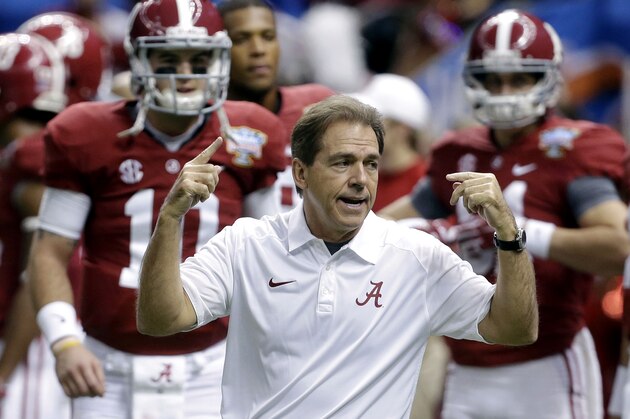 FILE - In this file photo from Jan. 2, 2014, Alabama head coach Nick Saban, center, calls drills as his team warms up before the NCAA college football Sugar Bowl against Oklahoma in New Orleans. The Southeastern Conference is still reigning supreme on the recruiting trail. The Crimson Tide is poised to bring in another top-rated recruiting class on Wednesday's, Feb. 5, 2014, national signing day. Six SEC rivals also have built top 10 classes, according to the 247Sports composite rankings of the major recruiting sites. (AP Photo/Rusty Costanza, File)