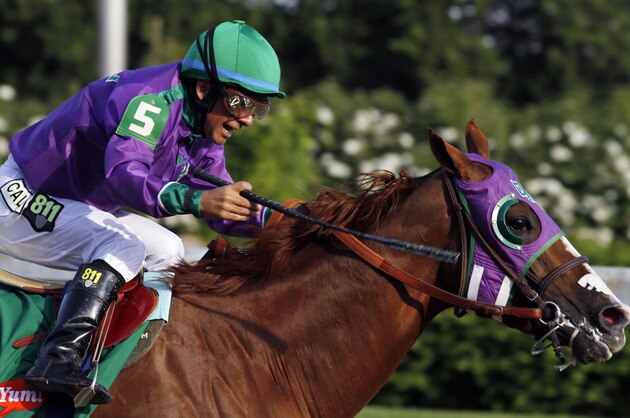 Victor Espinoza rides California Chrome to a victory during the 140th running of the Kentucky Derby horse race at Churchill Downs Saturday, May 3, 2014, in Louisville, Ky. (AP Photo/Garry Jones)