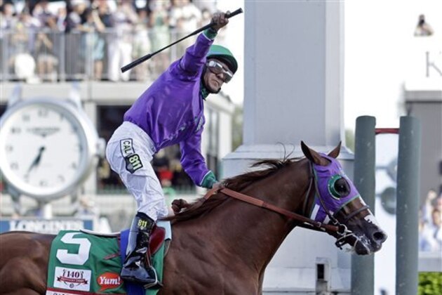 FILE - In this May 3, 2014, file photo, jockey Victor Espinoza celebrates aboard California Chrome after winning the 140th running of the Kentucky Derby horse race at Churchill Downs in Louisville, Ky. The California colt will be running in the Preakness with a bulls-eye on his back as perhaps racing's next superstar. He figures to face eight or nine rivals in the middle leg of the Triple Crown series, and one of them might be a filly.  (AP Photo/Morry Gash, File)