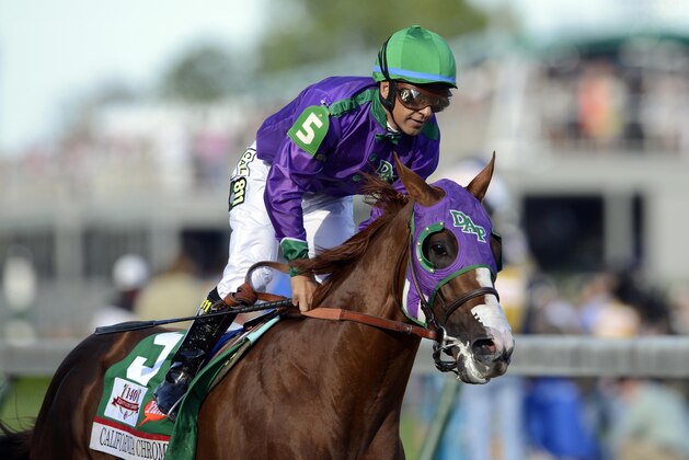 May 3, 2014; Louisville, KY, USA; Victor Espinoza aboard California Chrome (5) after winning the 2014 Kentucky Derby at Churchill Downs. Mandatory Credit: Jamie Rhodes-USA TODAY Sports