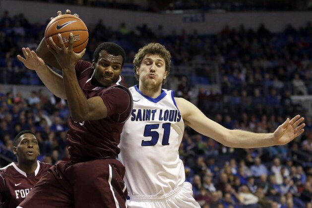 Fordham's Jon Severe, left, grabs a rebound along side Saint Louis' Rob Loe during the second half of an NCAA college basketball game Saturday, Jan. 18, 2014, in St. Louis. Saint Louis won 70-48. (AP Photo/Jeff Roberson)