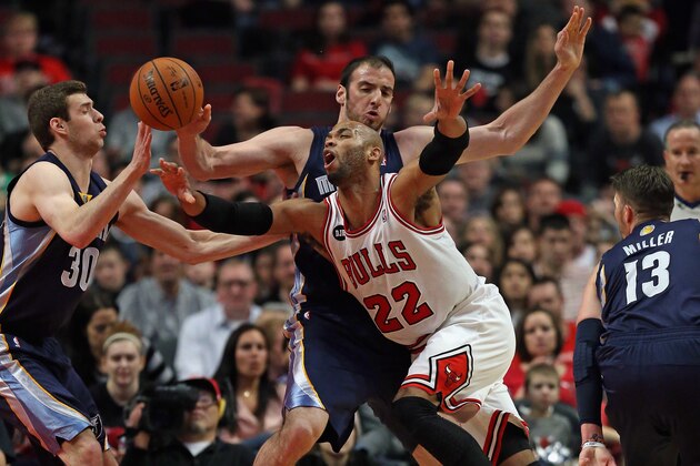 CHICAGO, IL - MARCH 07:  Taj Gibson #22 of the Chicago Bulls is fouled by Kosta Koufos #41 of the Memphis Grizzlies as he moves against Jon Leuer #30 at the United Center on March 7, 2014 in Chicago, Illinois. NOTE TO USER: User expressly acknowledges and agrees that, by downloading and or using this photograph, User is consenting to the terms and conditions of the Getty Images License Agreement.  (Photo by Jonathan Daniel/Getty Images)