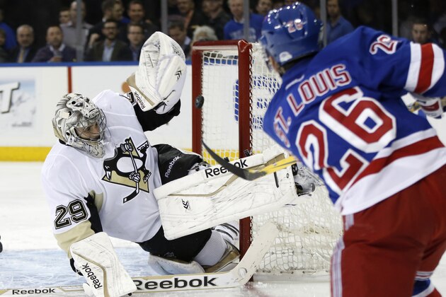 Pittsburgh Penguins goalie Marc-Andre Fleury (29) blocks a shot by New York Rangers right wing Martin St. Louis (26) in the second period of their second-round NHL Stanley Cup hockey playoff game at Madison Square Garden in New York, Monday, May 5, 2014.  (AP Photo/Kathy Willens)