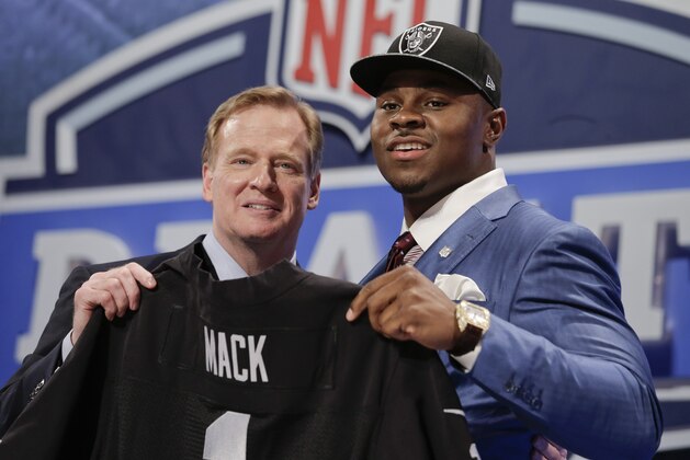 Buffalo linebacker Khalil Mack, right, poses for photos with NFL commissioner Roger Goodell after being selected by the Oakland Raiders as the fifth pick in the first round of the 2014 NFL Draft, Thursday, May 8, 2014, in New York. (AP Photo/Craig Ruttle)