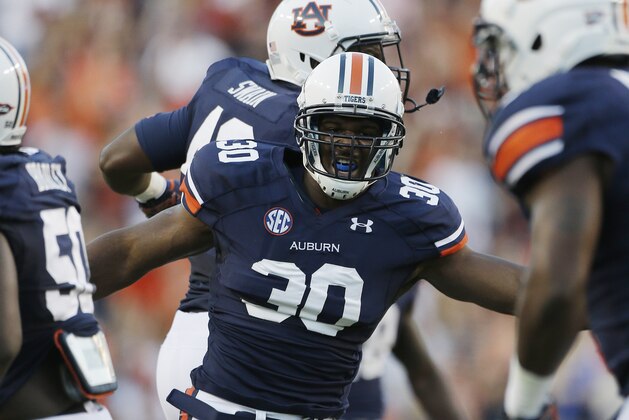 Auburn defensive end Dee Ford (30) celebrates in the first half of an NCAA college football game against Mississippi State in Auburn, Ala., Saturday, Sept. 14, 2013. (AP Photo/Dave Martin)