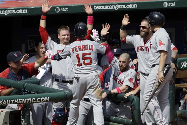Boston Red Sox's Dustin Pedroia (15) is congratulated at the top of the dugout by manager John Farrell, left,catcher A.J. Pierzynski and Mike Napoli, second from right, following his solo home run off Texas Rangers' Robbie Ross in the seventh inning of a baseball game on Sunday, May 11, 2014, in Arlington, Texas. (AP Photo/Tony Gutierrez)