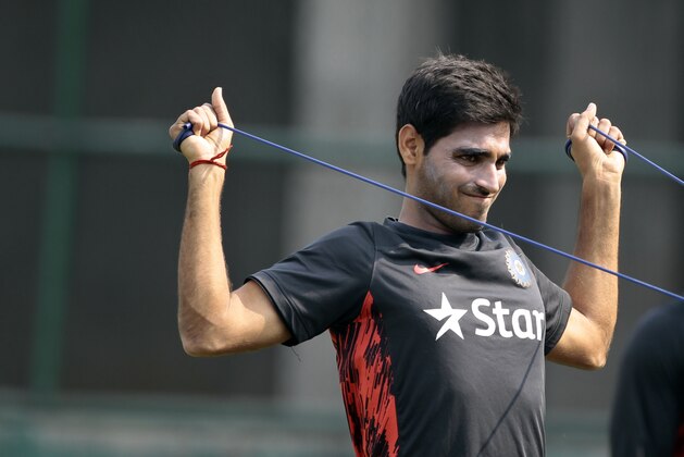 India’s Bhuvneshwar Kumar stretches during a practice session ahead of the Asia Cup tournament in Dhaka, Bangladesh, Monday, Feb. 24, 2014. Pakistan plays Sri Lanka in the opening match of the five nation one day cricket event that begins Tuesday. (AP Photo/A.M. Ahad)