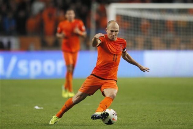 FILE - In this Oct. 11, 2013, file photo, In this Netherlands' Arjen Robben plays the ball during the Group D World Cup qualifying soccer match between Netherlands and Hungary, in Amsterdam, Netherlands. Robin van Persie and Arjen Robben continue to spark the Oranje, but Van Persie must seize the opportunity after the Manchester United striker has scored only once at the last two major tournaments, the 2010 World Cup and Euro 2012. (AP Photo/Peter Dejong, File)