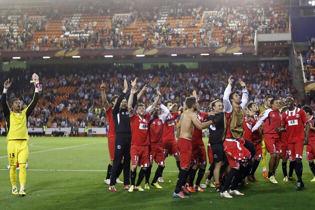 Sevilla team celebrates at the end of their Europa League semifinal second leg soccer match against Valencia at the Mestalla stadium in Valencia, Spain, Thursday, May 1, 2014. Valencia lost 2-0 in the first leg at Sevilla. The game ended 3-1. Sevilla qualified for the final Europa League. (AP Photo/Alberto Saiz)