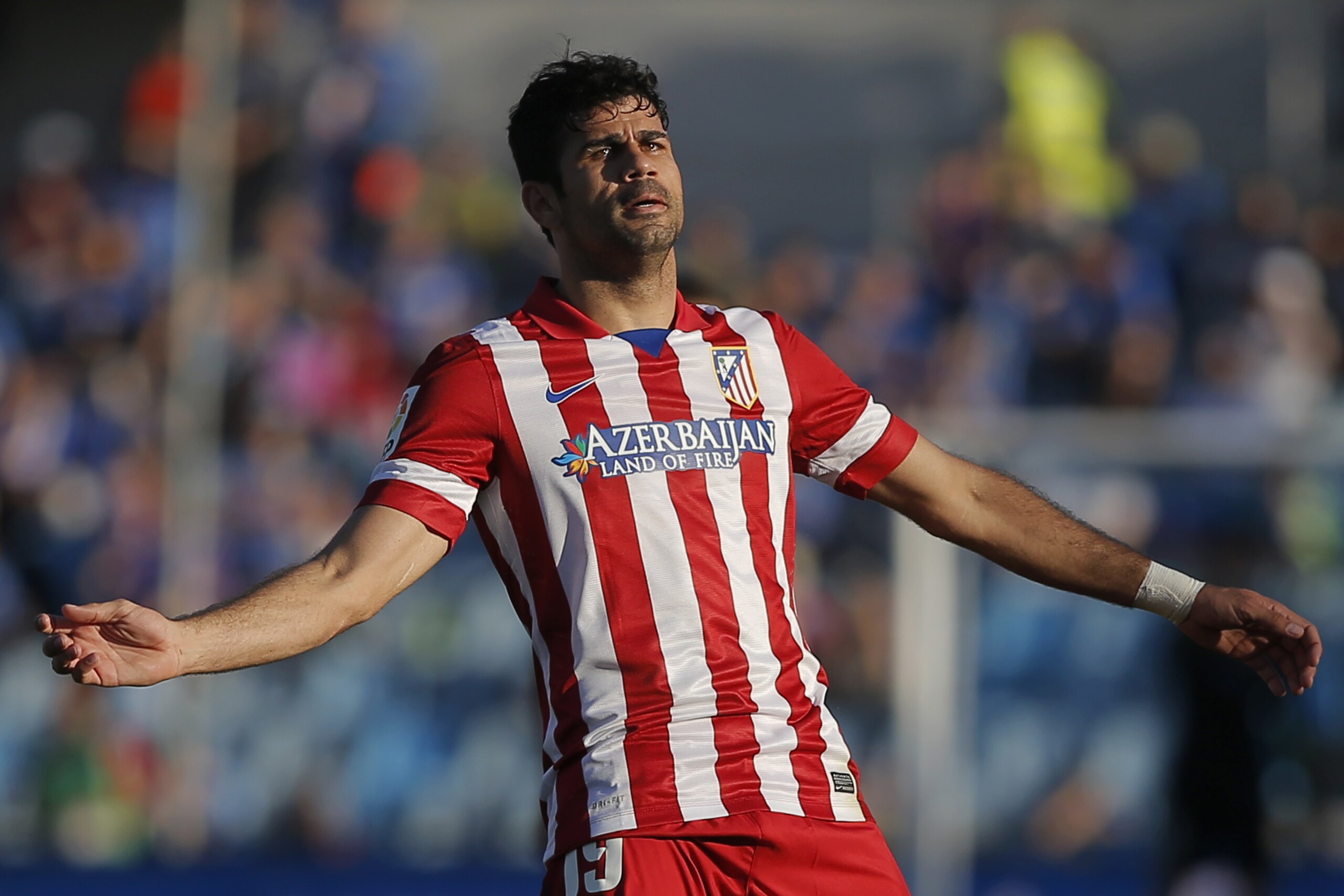 Atletico's Diego Costa gestures during a Spanish La Liga soccer match between Getafe and Atletico Madrid at the Coliseum Alfonso Perez  stadium in Madrid, Spain, Sunday, April 13, 2014. (AP Photo/Andres Kudacki)
