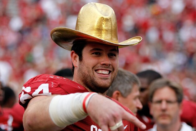 DALLAS, TX - OCTOBER 13:  Gabe Ikard #64 of the Oklahoma Sooners celebrates with the AT&T Red River Rivalry trophy after the Oklahoma Sooners beat the Texas Longhorns 63-21 at Cotton Bowl on October 13, 2012 in Dallas, Texas.  (Photo by Tom Pennington/Getty Images)