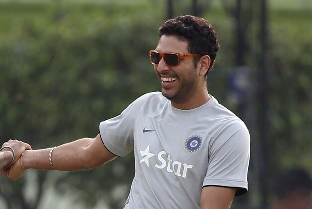 India's Yuvraj Singh, second left, shares a light moment with teammates during a training session ahead of their ICC Twenty20 Cricket World Cup final match against Sri Lanka in Dhaka, Bangladesh, Saturday, April 5, 2014. (AP Photo/Aijaz Rahi)