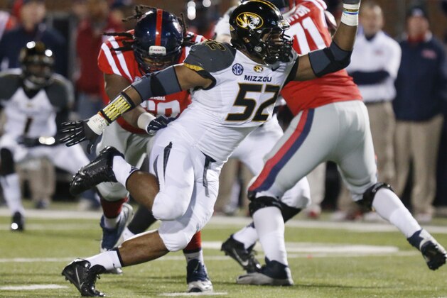 FILE - In this Nov. 23, 2013, file photo, Missouri defensive lineman Michael Sam (52) pushes past a block by Mississippi offensive linesman Pierce Burton (71) during the second half of an NCAA college football game in Oxford, Miss. Sam was selected in the seventh round, 249th overall, by the St. Louis Rams in the NFL draft Saturday, May 10, 2014. The Southeastern Conference defensive player of the year last season for Missouri came out as gay in media interviews this year. (AP Photo/Rogelio V. Solis, File)