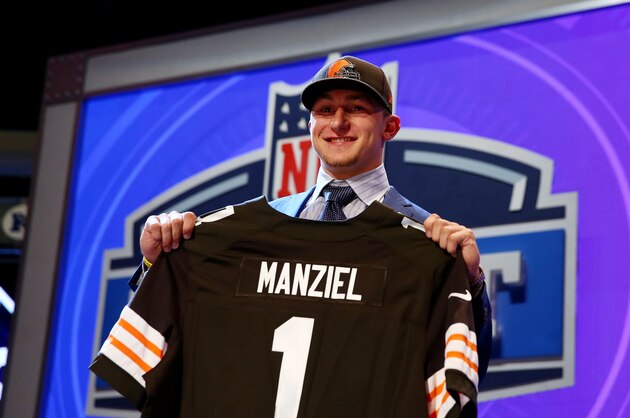 NEW YORK, NY - MAY 08:  Johnny Manziel of the Texas A&M Aggies poses with a jersey after he was picked #22 overall by the Cleveland Browns during the first round of the 2014 NFL Draft at Radio City Music Hall on May 8, 2014 in New York City.  (Photo by Elsa/Getty Images)