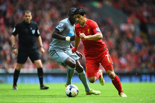 LIVERPOOL, ENGLAND - MAY 11:  Luis Suarez of Liverpool takes on Moussa Sissoko of Newcastle United during the Barclays Premier League match between Liverpool and Newcastle United at Anfield on May 11, 2014 in Liverpool, England.  (Photo by Laurence Griffiths/Getty Images)