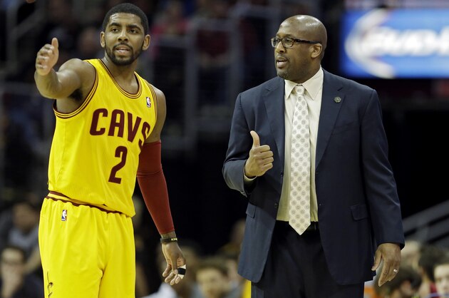 Cleveland Cavaliers' Kyrie Irving (2) talks with head coach Mike Brown in an NBA basketball game against the Charlotte Bobcats Saturday, April 5, 2014, in Cleveland. (AP Photo/Mark Duncan)
