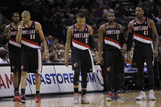 Portland Trail Blazers' LaMarcus Aldridge, left, Nicolas Batum (88), Damian Lillard (0), Wesley Matthews (2), and Thomas Robinson (41) walk on to the court following a time out during the first half of Game 2 of a Western Conference semifinal NBA basketball playoff series against the San Antonio Spurs, Thursday, May 8, 2014, in San Antonio.  (AP Photo/Eric Gay)
