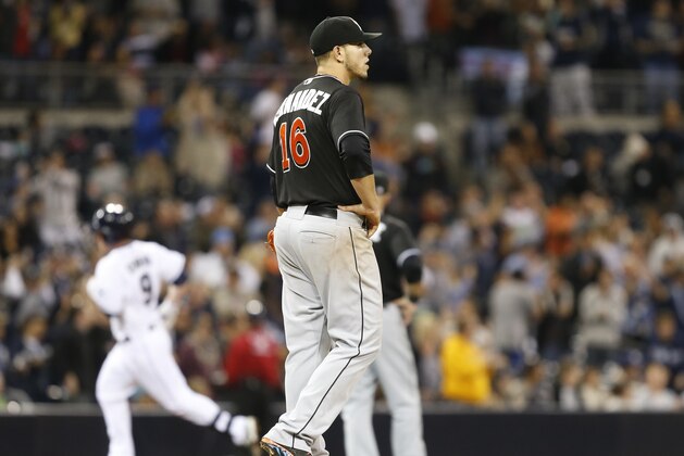 Miami Marlins starting pitcher Jose Fernandez stares into the outfield as San Diego Padres' Jedd Gyorko rounds the bases with a grand slam home run during the sixth inning of a baseball game Friday, May 9, 2014, in San Diego.  (AP Photo/Lenny Ignelzi)