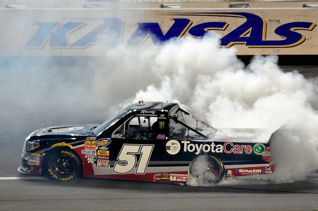 KANSAS CITY, KS - MAY 09: Kyle Busch, driver of the #51 ToyotaCare Toyota, celebrates with a burnout after winning the NASCAR Camping World Truck Series SFP 250 at Kansas Speedway on May 9, 2014 in Kansas City, Kansas.  (Photo by Jared C. Tilton/Getty Images)