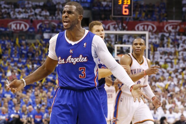 Los Angeles Clippers guard Chris Paul (3) complains to an official in front of Oklahoma City Thunder guard Russell Westbrook (0) in the third quarter of Game 2 of the Western Conference semifinal NBA basketball playoff series in Oklahoma City, Wednesday, May 7, 2014. Oklahoma City won 112-101. (AP Photo/Sue Ogrocki)