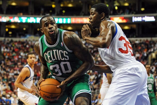 Apr 14, 2014; Philadelphia, PA, USA; Boston Celtics forward Brandon Bass (30) drives to the net as Philadelphia 76ers center Henry Sims (35) defends in the second quarter of the game at Wells Fargo Center. The Philadelphia 76ers won 113-108. Mandatory Credit: John Geliebter-USA TODAY Sports