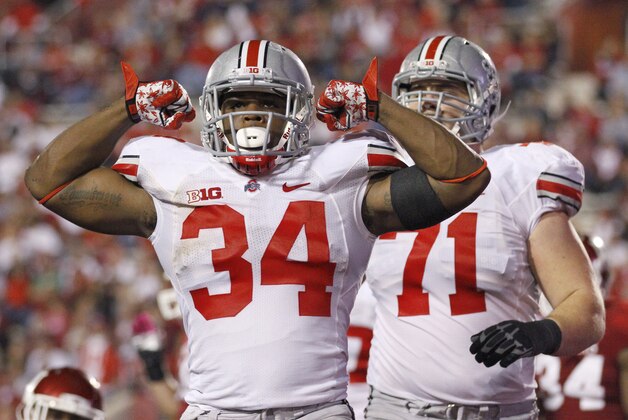 FILE - In this Oct. 13, 2012 file photo, Ohio State running back Carlos Hyde (34) celebrates after scoring a touchdown during the second half of an NCAA college football game against Indiana in Bloomington, Ind. A published report says Ohio State coach Urban Meyer has kicked top rusher Carlos Hyde off the team after an alleged assault against a female in Columbus. The Columbus Dispatch is reporting that Hyde was named as a person of interest in a weekend assault against a female in a downtown Columbus bar. The newspaper cites sources saying Hyde was dismissed from the team over the incident early Saturday, July 20, 2013. (AP Photo/Sam Riche, File)
