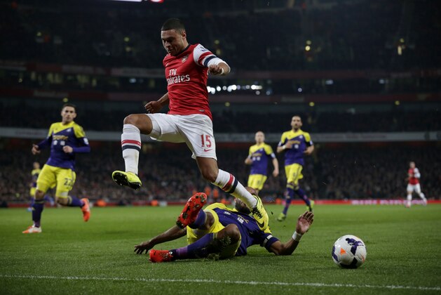 Arsenal's Alex Oxlade-Chamberlain, top, competes for the ball with Swansea City's Ashley Williams during the English Premier League soccer match between Arsenal and Swansea City at the Emirates Stadium in London, Tuesday, March 25, 2014. (AP Photo/Matt Dunham) Arsenal's Alex Oxlade-Chamberlain, top, competes for the ball with Swansea City's Ashley Williams during the English Premier League soccer match between Arsenal and Swansea City at the Emirates Stadium in London, Tuesday, March 25, 2014. (AP Photo/Matt Dunham)