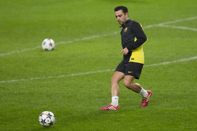 Barcelona's Xavi Hernandez trains with teammates at Manchester City's Etihad Stadium, Manchester, England, Monday Feb. 17, 2014. Barcelona will play Manchester City on Tuesday in a Champions League first knock out round soccer match. (AP Photo/Jon Super)