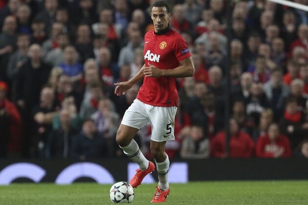 FILE - A Tuesday April 1, 2014 photo from files showing Manchester United's Rio Ferdinand controling a ball during the Champions League quarterfinal first leg soccer match between Manchester United and Bayern Munich at Old Trafford Stadium, Manchester, England. Rio Ferdinand says he is leaving Manchester United after 12 years at the Premier League club but is set to continue playing. The 35-year-old former England defender has not been offered an extension to his contract that expires next month. (AP Photo/Jon Super, File)
