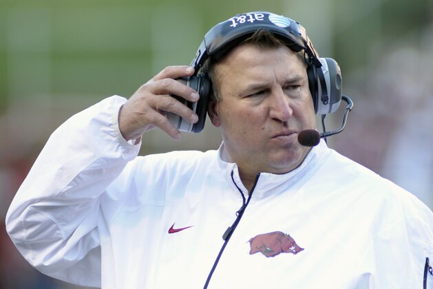 Arkansas coach Bret Bielema adjusts his headphones in the first half of an NCAA college football game against Auburn in Fayetteville, Ark., Saturday, Nov. 2, 2013. (AP Photo/Beth Hall)