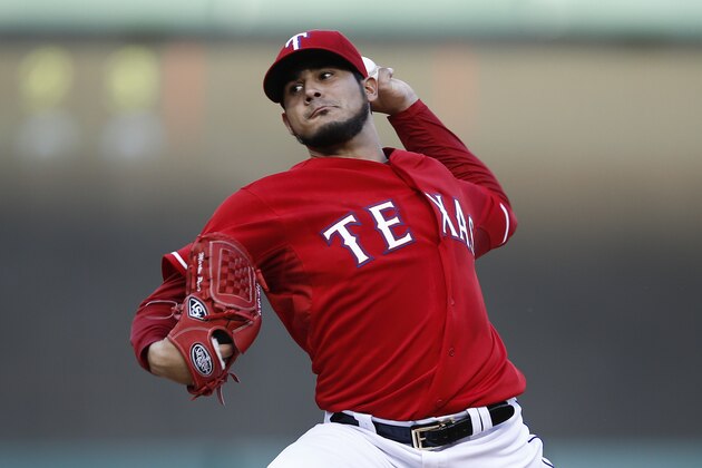 Texas Rangers starting pitcher Martin Perez (33) throws to the Boston Red Sox during the first inning of a baseball game, Saturday, May 10, 2014, in Arlington, Texas. (AP Photo/Jim Cowsert)