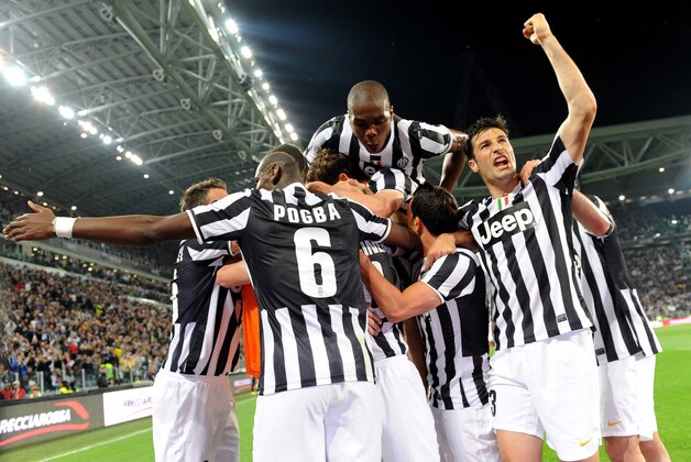 Juventus players celebrate after their teammate Simone Padoin, at center, scored during a Serie A soccer match between Juventus and Atalanta at the Juventus stadium, in Turin, Italy, Monday, May 6, 2014. (AP Photo/Massimo Pinca)