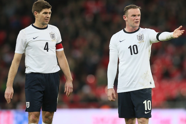 England's Steven Gerrard, left, talks to teammate England's Wayne Rooney as they wait to take a free kick during the international friendly soccer match between England and Denmark at Wembley stadium in London Wednesday, March  5,  2014. (AP Photo/Alastair Grant)