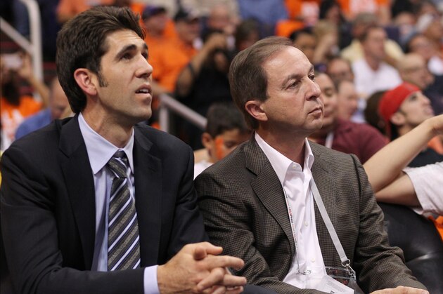 Golden State Warriors owner Joe Lacob, right, and general manager Bob Myers, left, watch game action against the Phoenix Suns in an NBA basketball game Wednesday, Oct. 31, 2012, in Phoenix.(AP Photo/Paul Connors)