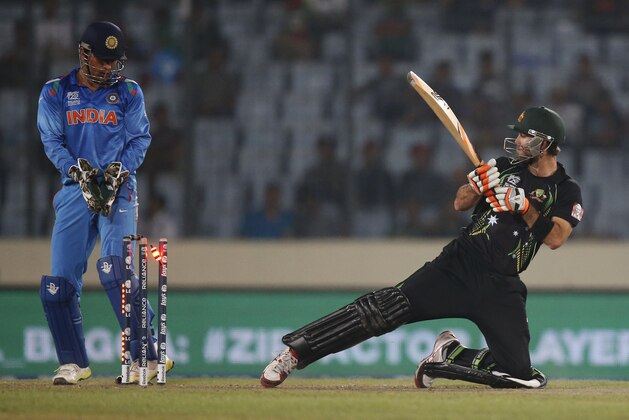 Australia's batsman Glenn Maxwell, right, is bowled out by India's bowler Ravichandran Ashwin during their ICC Twenty20 Cricket World Cup match in Dhaka, Bangladesh, Sunday, March 30, 2014. (AP Photo/Aijaz Rahi)
