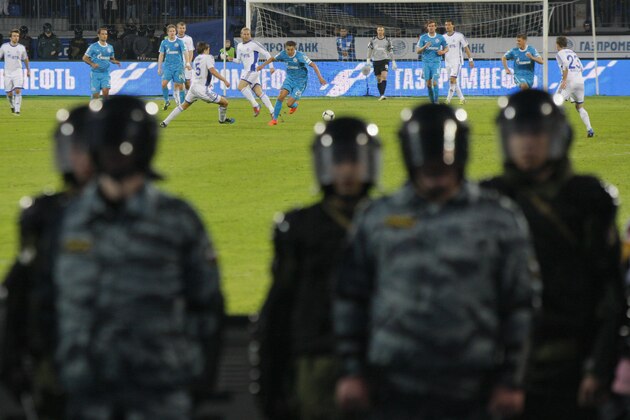 Riot police guard during the Russian Premier League Championship soccer match between Zenit and Dinamo Moscow at Petrovsky stadium in St.Petersburg, Russia, Saturday, April 28, 2012. (AP Photo/Dmitry Lovetsky)