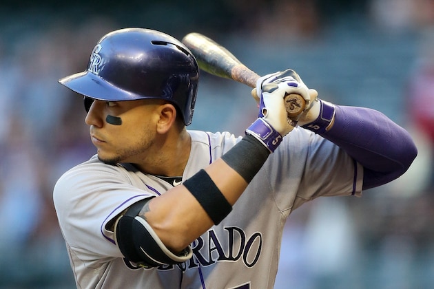 PHOENIX, AZ - APRIL 30:  Carlos Gonzalez #5 of the Colorado Rockies bats against the Arizona Diamondbacks during the first inning of the MLB game at Chase Field on April 30, 2014 in Phoenix, Arizona.  (Photo by Christian Petersen/Getty Images)